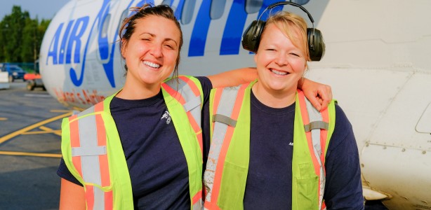 Two cheerful Air North ramp agents next to one of the airline's ATR turboprops.