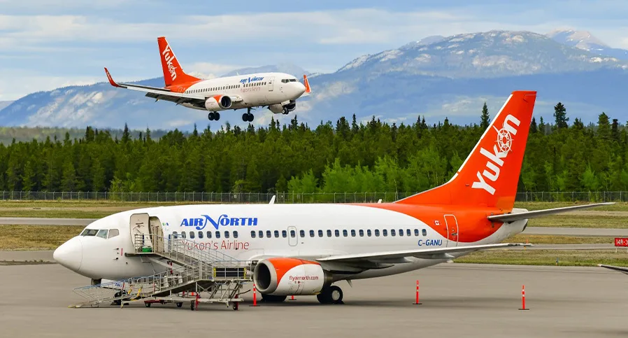 AirNorth aircraft landing and an AirNorth aircraft taxing.