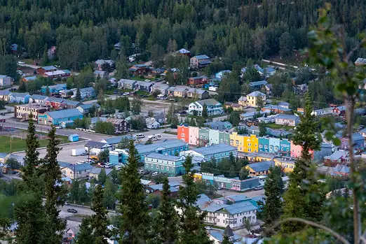 A Photo of Dawson city from higher ground. Looking at colourful buildings