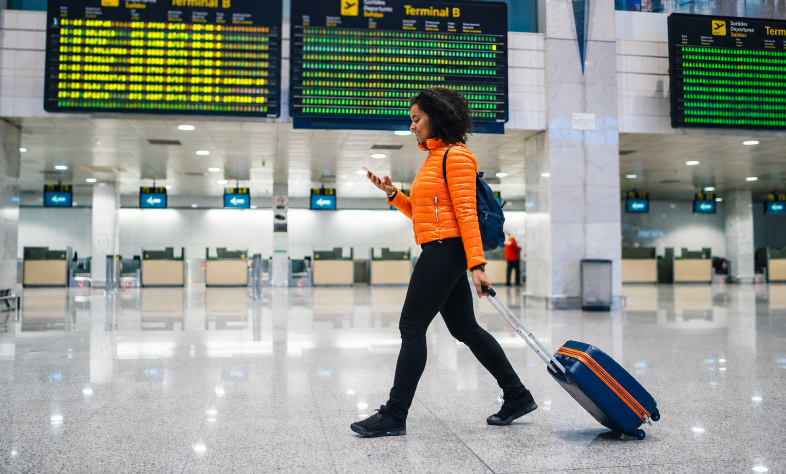 student using flex pass walking in airport checking flight details
