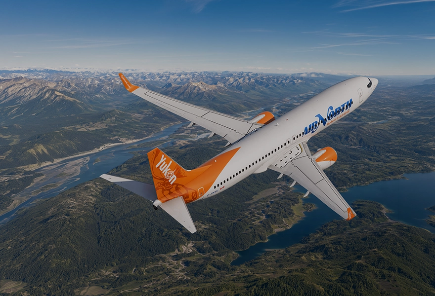 737-800 flying over landscape