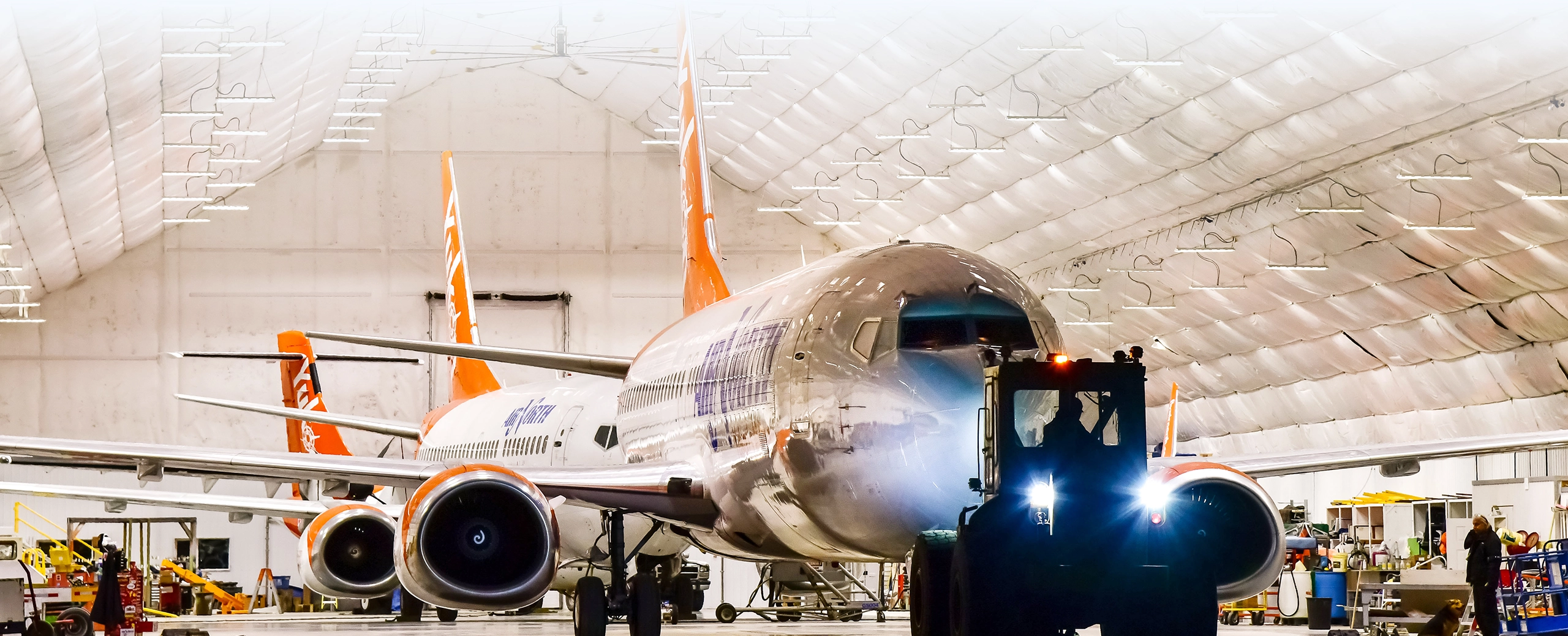 Air North fleet in hangar being taxied out to runway
