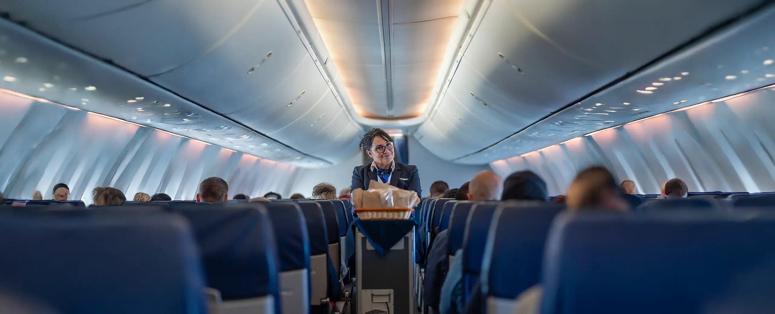 Onboard 737-800 flight, crew and flight attendant smiles during inflight service