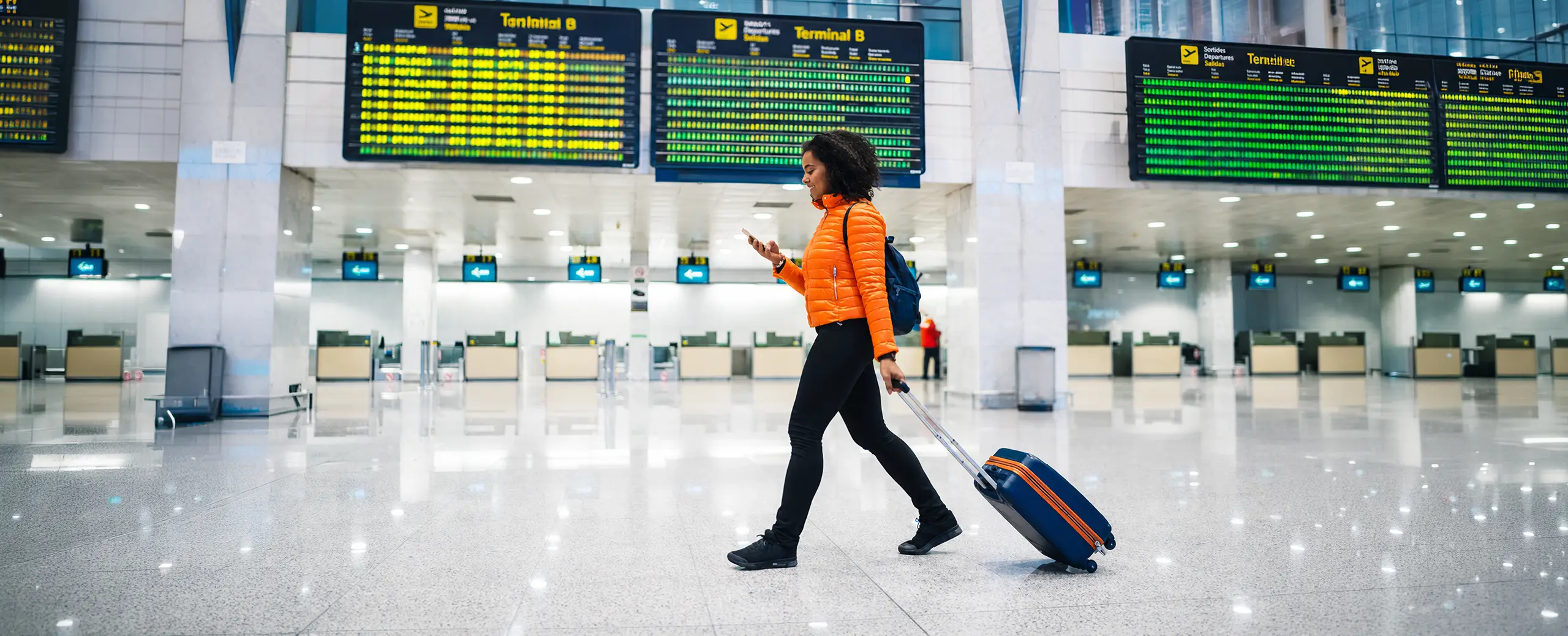 student using flex pass walking in airport checking flight details